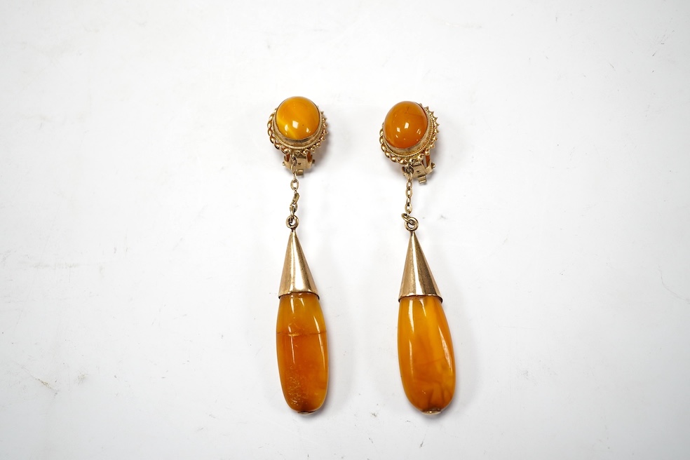 A pair of yellow metal and two stone amber set drop ear clips, 68mm, gross weight 8 grams. Condition - poor